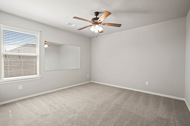 carpeted spare room with ceiling fan