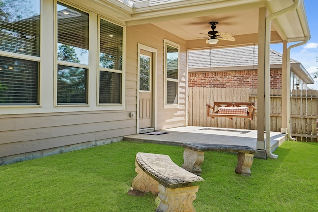 exterior space with a yard and ceiling fan