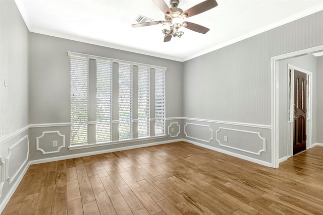 spare room featuring ceiling fan, light wood-type flooring, and ornamental molding