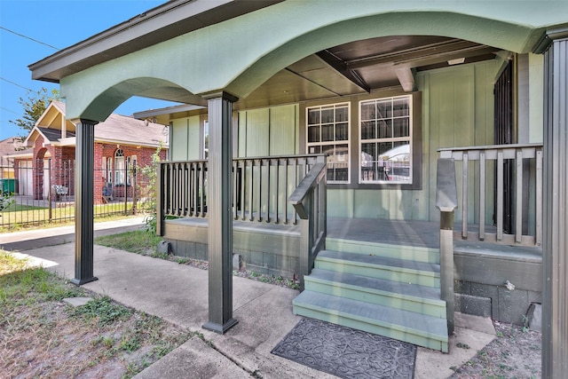 view of exterior entry featuring a porch