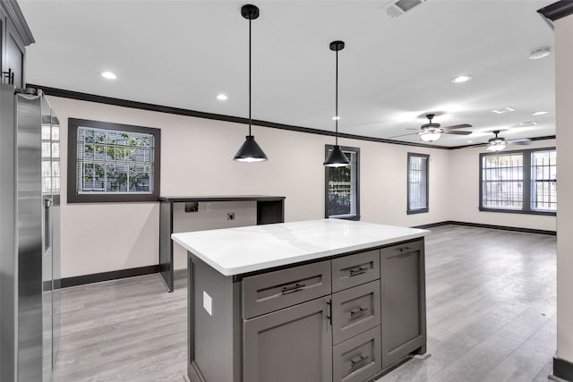 kitchen featuring light hardwood / wood-style floors, gray cabinetry, pendant lighting, a kitchen island, and stainless steel fridge with ice dispenser