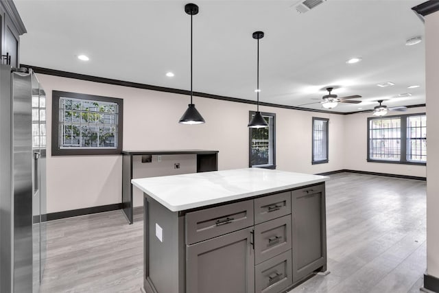 kitchen featuring stainless steel fridge with ice dispenser, visible vents, gray cabinets, crown molding, and baseboards