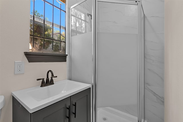 bathroom featuring toilet, walk in shower, and vanity