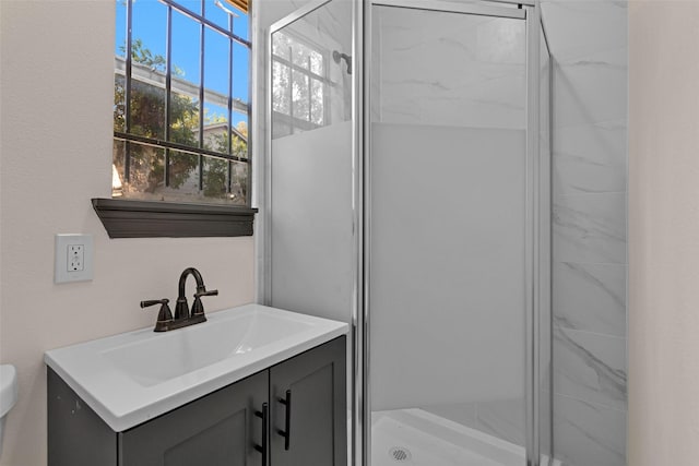 full bath with toilet, vanity, and a stall shower