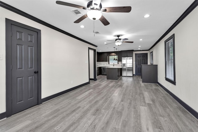 unfurnished living room featuring baseboards, visible vents, recessed lighting, ceiling fan, and crown molding