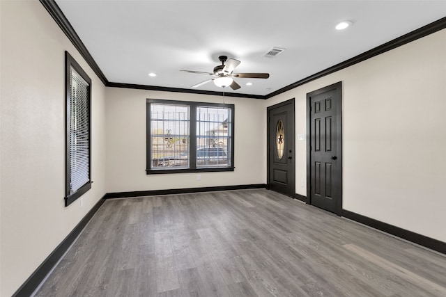 unfurnished bedroom featuring ornamental molding, ceiling fan, and light hardwood / wood-style flooring