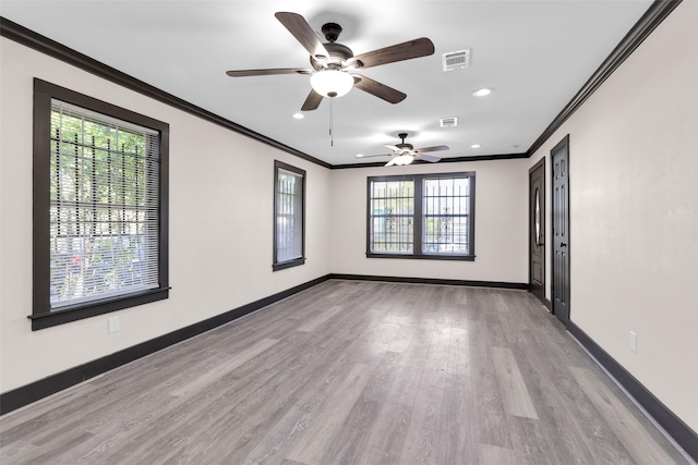 spare room with ceiling fan, baseboards, ornamental molding, visible vents, and recessed lighting