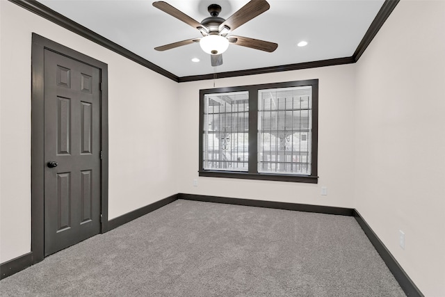 empty room with carpet floors, ornamental molding, and ceiling fan