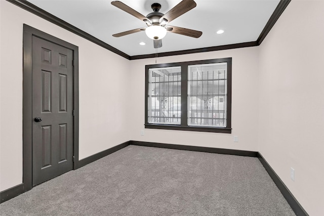 unfurnished room with ceiling fan, baseboards, ornamental molding, and carpet flooring