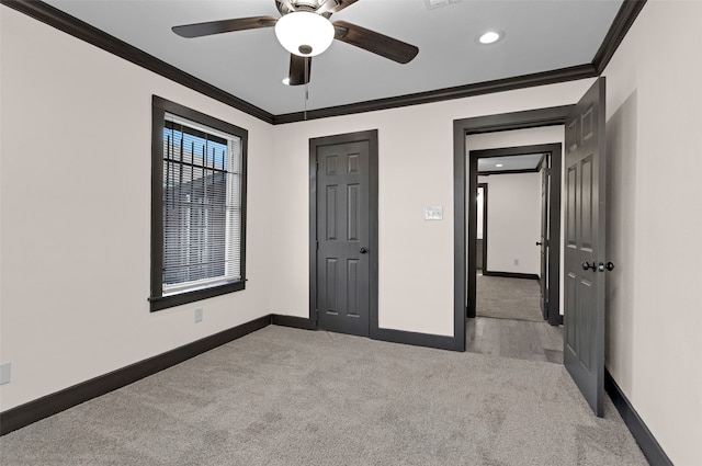 unfurnished bedroom with ceiling fan, light colored carpet, and ornamental molding