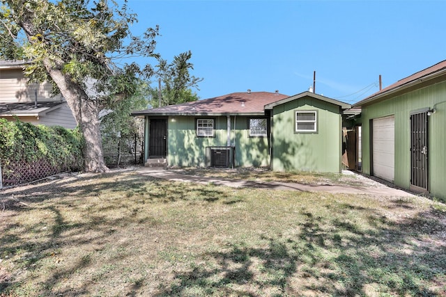 back of property with a lawn