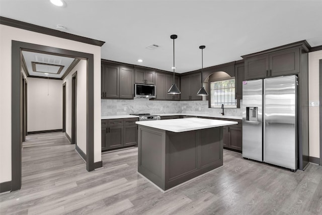 kitchen featuring appliances with stainless steel finishes, tasteful backsplash, crown molding, and light countertops