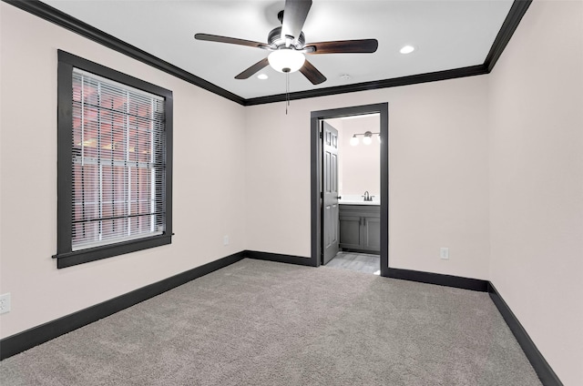 unfurnished bedroom featuring light carpet, baseboards, recessed lighting, and crown molding