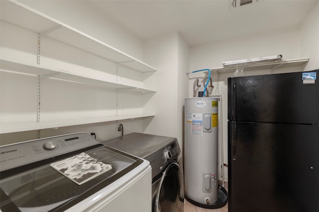 clothes washing area with water heater and washing machine and dryer