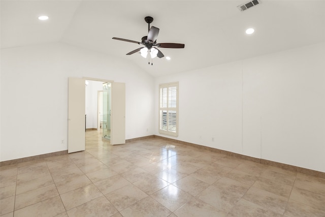 spare room featuring light tile patterned flooring, vaulted ceiling, and ceiling fan