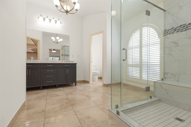 bathroom with walk in shower, an inviting chandelier, vanity, and toilet