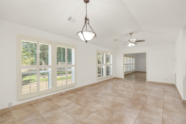 tiled spare room featuring ceiling fan, lofted ceiling, and a healthy amount of sunlight