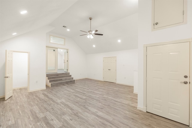 unfurnished living room featuring ceiling fan, light wood-type flooring, and high vaulted ceiling