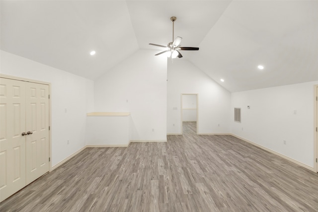 interior space featuring ceiling fan, vaulted ceiling, and light hardwood / wood-style floors