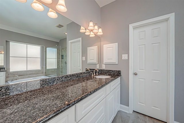 bathroom with tile patterned flooring, vanity, and separate shower and tub