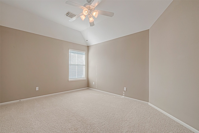 empty room featuring carpet floors, vaulted ceiling, and ceiling fan