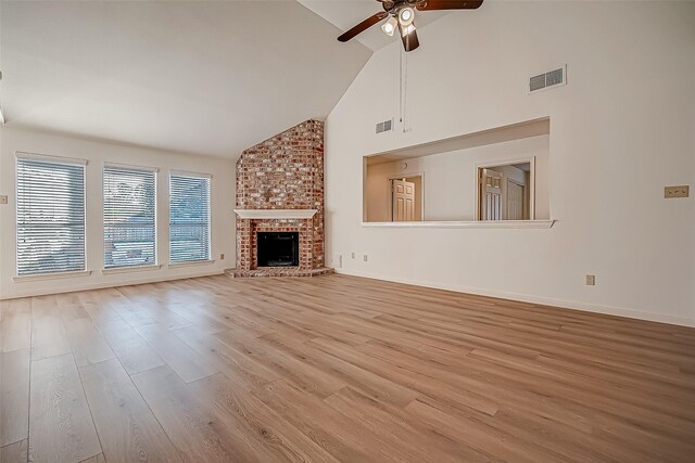 2810 Pineleaf Dr, Sugar Land, TX 77479 - unfurnished living room with a ceiling fan, high vaulted ceiling, wood finished floors, a fireplace, and baseboards