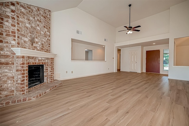 2810 Pineleaf Dr, Sugar Land, TX 77479 - unfurnished living room featuring ceiling fan, wood finished floors, a brick fireplace, high vaulted ceiling, and baseboards