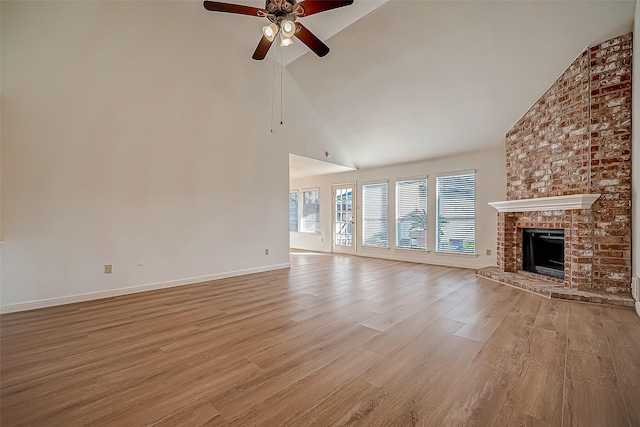 2810 Pineleaf Dr, Sugar Land, TX 77479 - unfurnished living room featuring high vaulted ceiling, a ceiling fan, light wood-style flooring, a fireplace, and baseboards