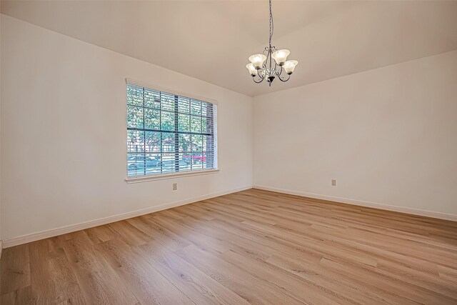 2810 Pineleaf Dr, Sugar Land, TX 77479 - spare room with a chandelier, light wood finished floors, and baseboards