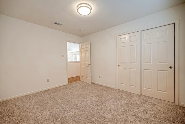 2810 Pineleaf Dr, Sugar Land, TX 77479 - unfurnished bedroom with carpet flooring, baseboards, and a closet