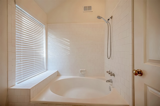 bathroom featuring lofted ceiling