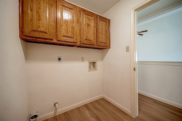 laundry room with washer hookup, cabinets, wood-type flooring, gas dryer hookup, and hookup for an electric dryer