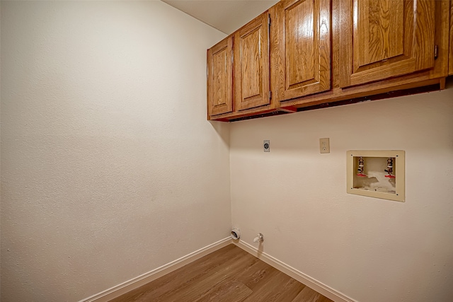 washroom with wood-type flooring, hookup for a washing machine, cabinets, and electric dryer hookup