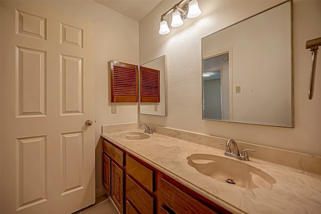 bathroom featuring tile patterned flooring and vanity