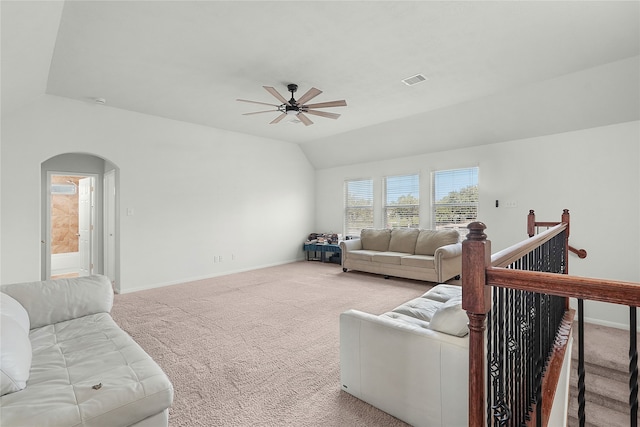 carpeted living room featuring ceiling fan and vaulted ceiling