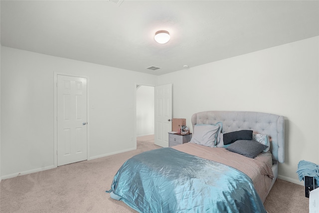 bedroom with light colored carpet