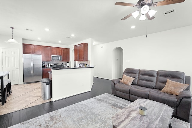 living room featuring ceiling fan and light wood-type flooring