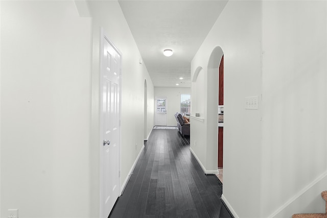 corridor with dark hardwood / wood-style floors