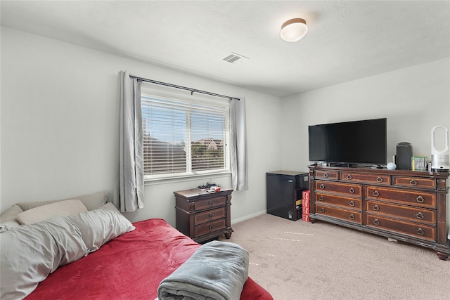 bedroom featuring light carpet