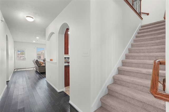 stairs featuring hardwood / wood-style flooring