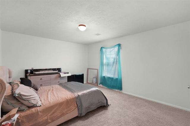 bedroom featuring light carpet