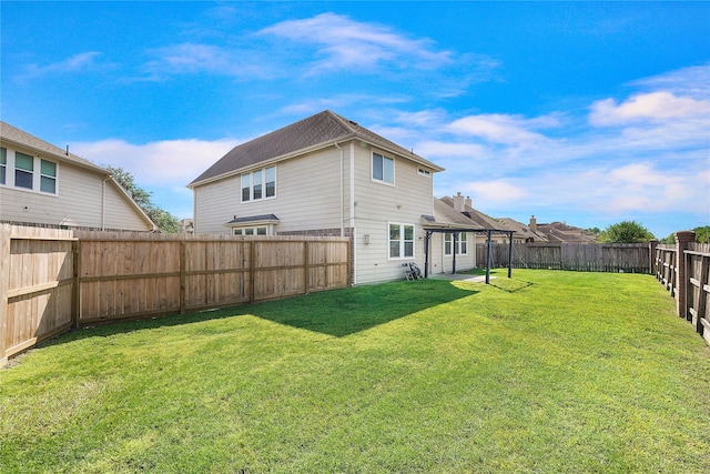 back of house with a lawn