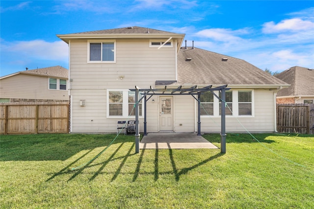 rear view of property featuring a yard, a pergola, and a patio