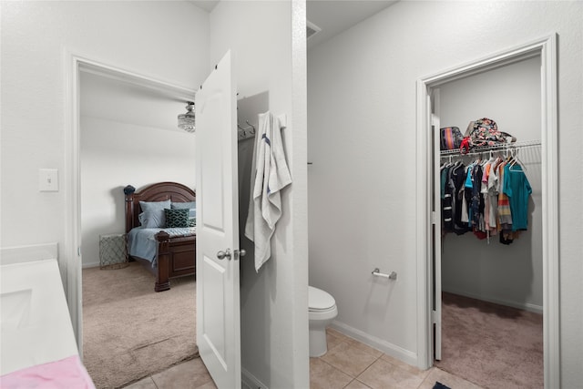 bathroom with tile patterned flooring and toilet