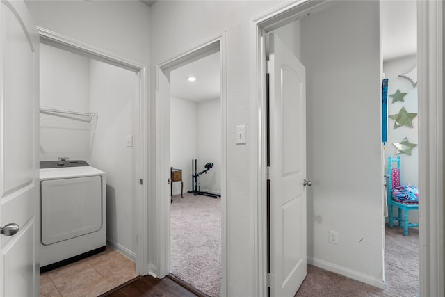 washroom featuring light carpet and washer / dryer