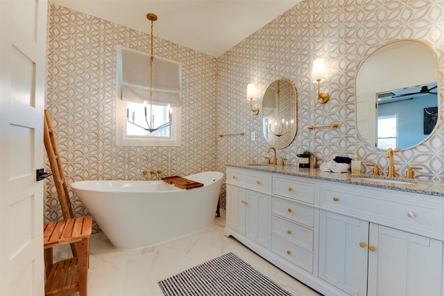 bathroom featuring vanity, a healthy amount of sunlight, and a bath