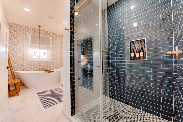 bathroom featuring shower with separate bathtub