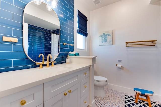 bathroom with vanity, a shower with shower curtain, toilet, and tile patterned floors