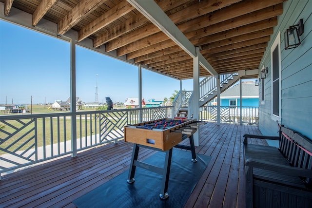 wooden deck featuring a lawn