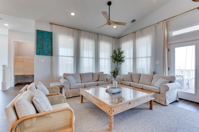 living room with lofted ceiling, hardwood / wood-style floors, and ceiling fan